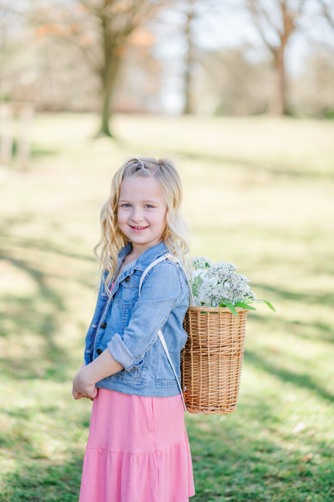 Girl standing with flower backpack during Spring Family Photoshoot in Wilmington, Delaware