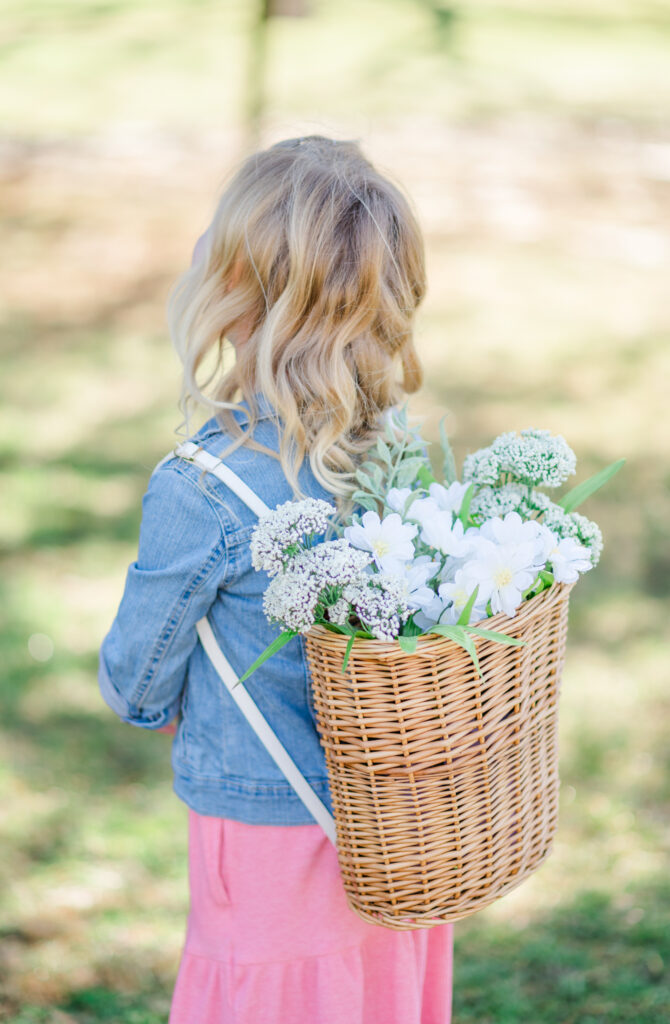 Girl standing with flower backpack during Spring Family Photoshoot in Wilmington, Delaware