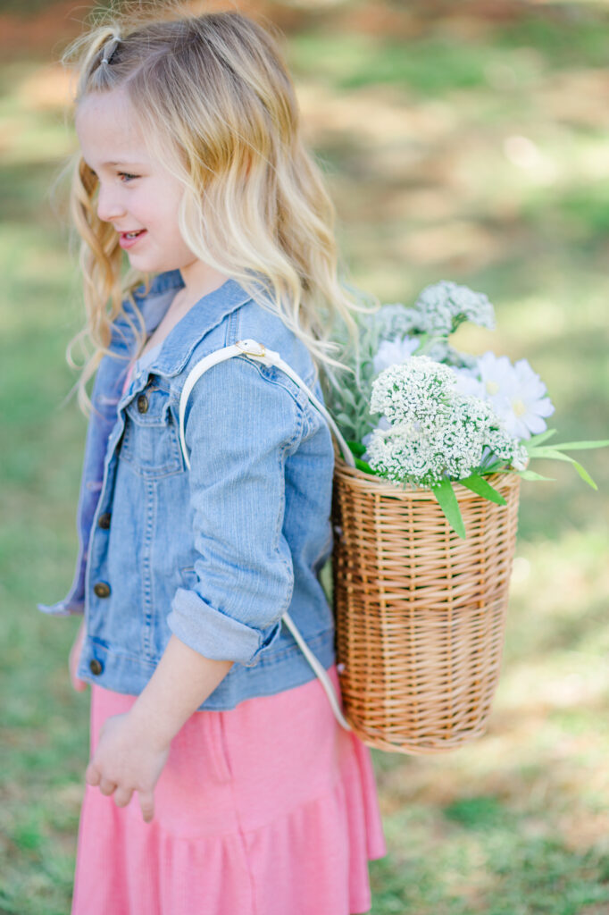 Girl standing with flower backpack during Spring Family Photoshoot in Wilmington, Delaware