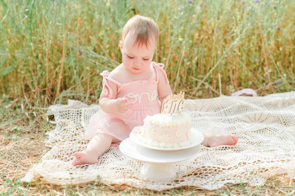 Baby's first birthday milestone session. Photographs of baby eating their smash cake